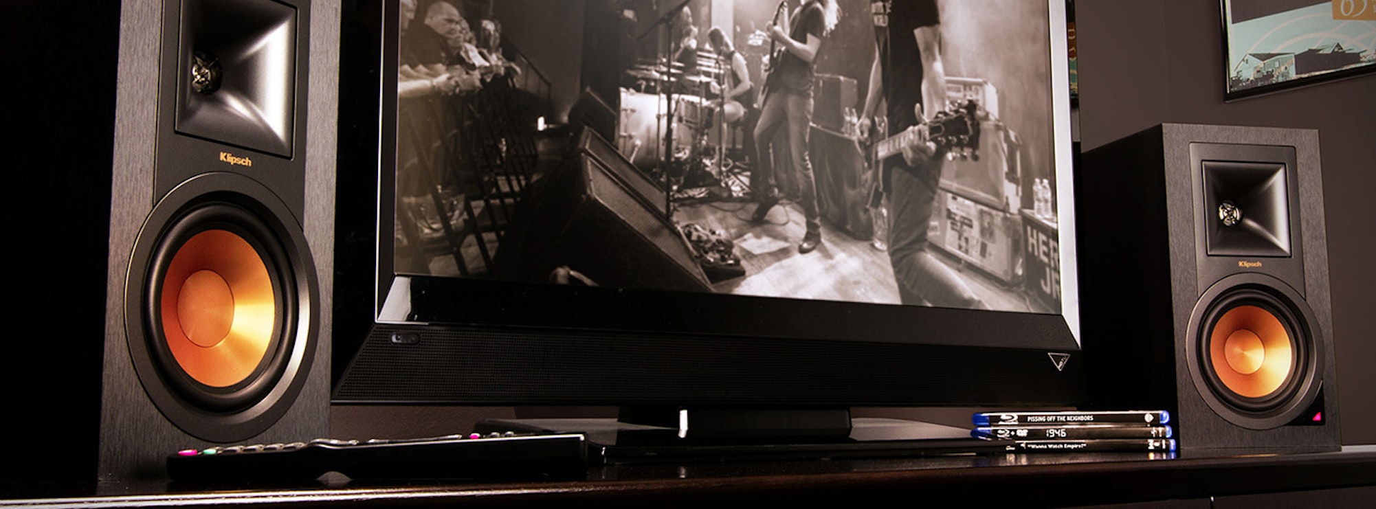R-15PM powered speakers flanking a tv